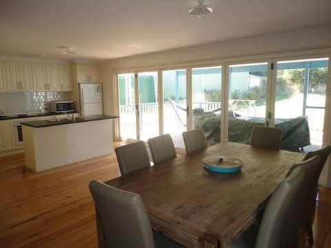 comfortable open plan dining area for social fun eating and hanging out opens up via 6 bifold doors to outdoor eating and full undercover area. Sit outside safe from sun wind and rain - all purpose undercover area