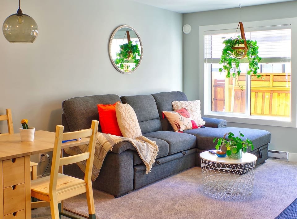 Living room and dining room. Couch converts to a queen bed, relax w/ a book, puzzle or game, watch Netflix or drift off for a nap. 