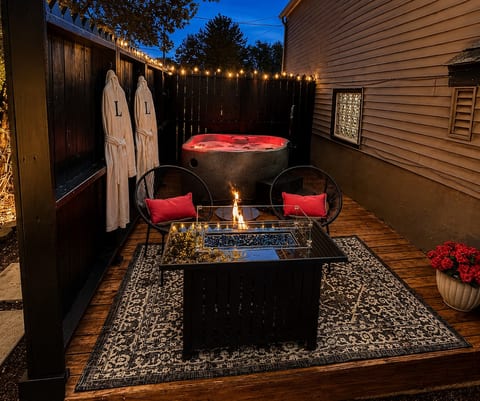 Private outdoor oasis-hot tub, fire table and monogrammed robes under the stars