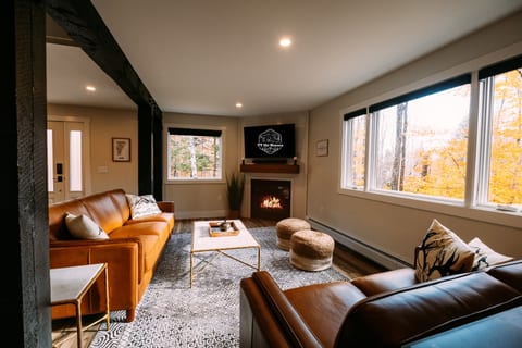 1st Floor Living Space with leather seating, tv and fireplace.