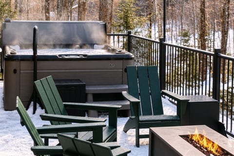 Back deck with hot tub and lounge area overlooking the Vermont Woods