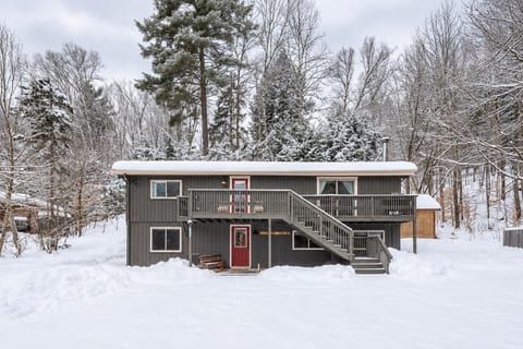 The front of cozy Between the Pines Cabin Retreat after a snow fall. The home is shoveled for you.