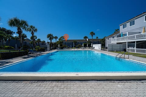 Poolside Paradise: Dive into fun just steps from your door, with the sun shining bright! Resort swimming pool is right across from home