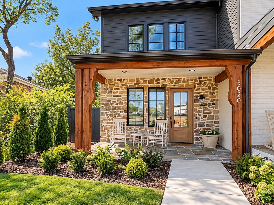 Charming covered front porch with rocking chairs and standout curb appeal