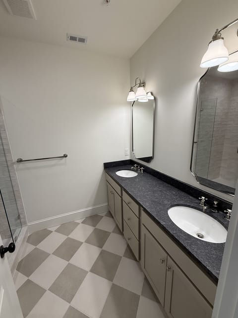 Spacious double-vanity bathroom with walk-in glass shower