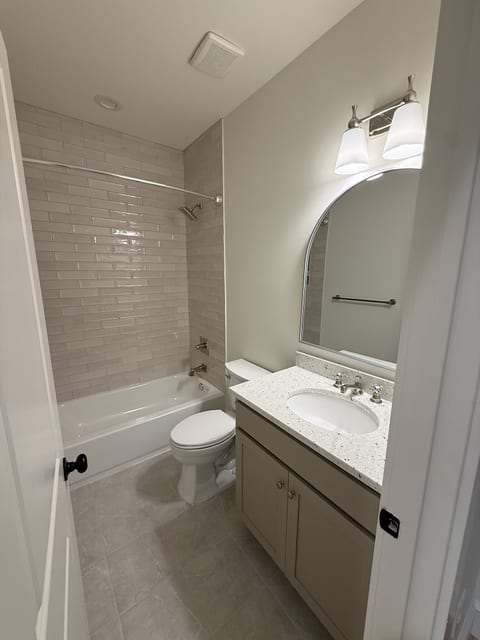Bright modern bathroom with subway tile shower and sleek vanity