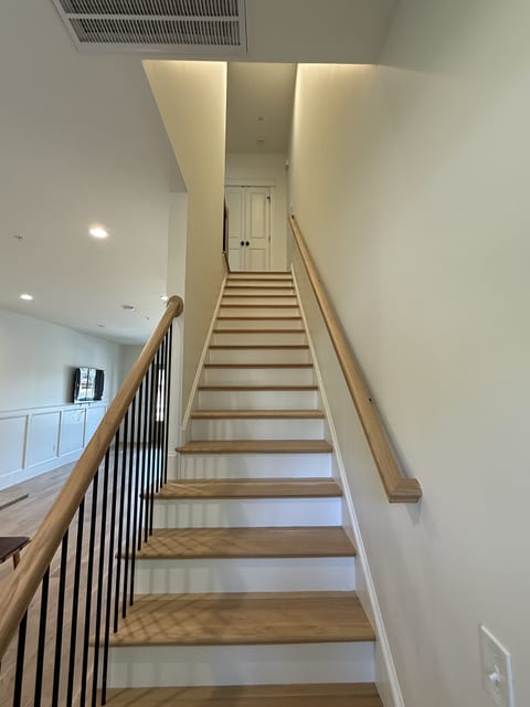 Modern open stairwell with warm wood accents and sleek architectural design