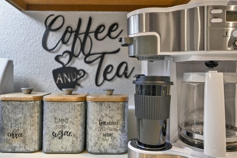 Charming coffee & tea station with stylish canisters and drip brewer