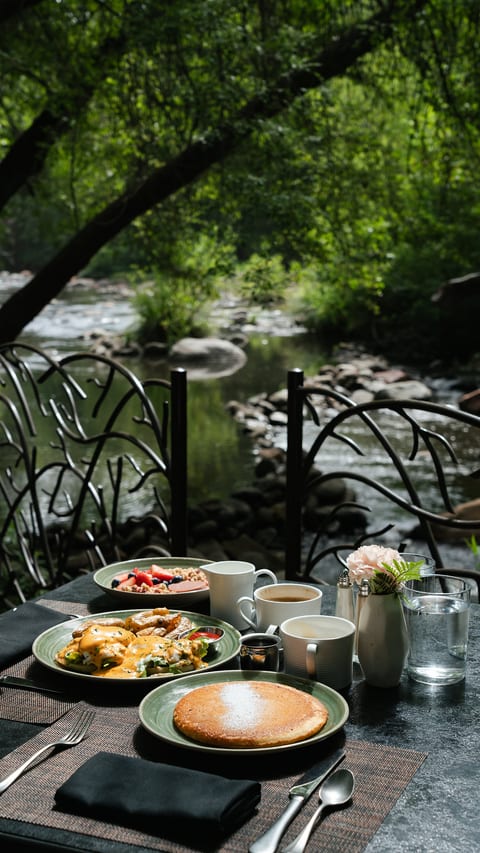 Creekside outdoor breakfast surrounded by lush, peaceful greenery just minutes away