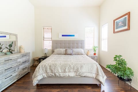 Bright, serene bedroom with high ceilings, natural light, and minimalist style
