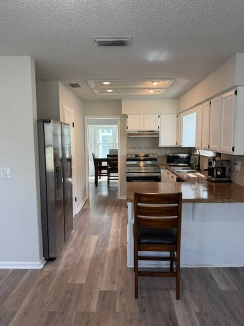 Fully Equipped Kitchen: A bright, modern kitchen featuring stainless steel appliances, ample counter space, and everything you need to cook home-cooked meals during your stay.