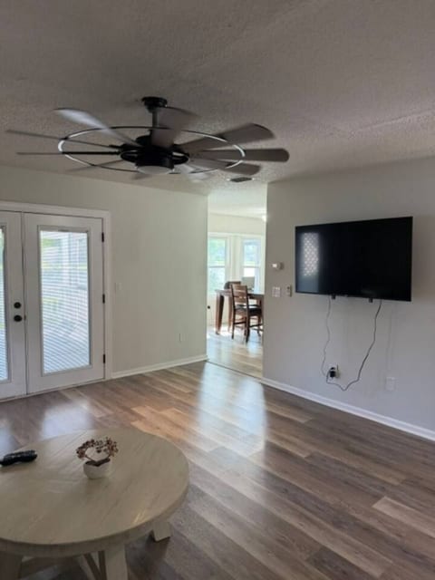 Spacious & Inviting: The open living area centers around a roomy sectional and a sleek mounted TV, creating a welcoming space to unwind, connect, and enjoy island living.