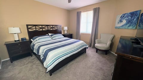 Master bedroom with a king bed, ensuite bath, walk-in closet, sound machine, and blackout curtains.