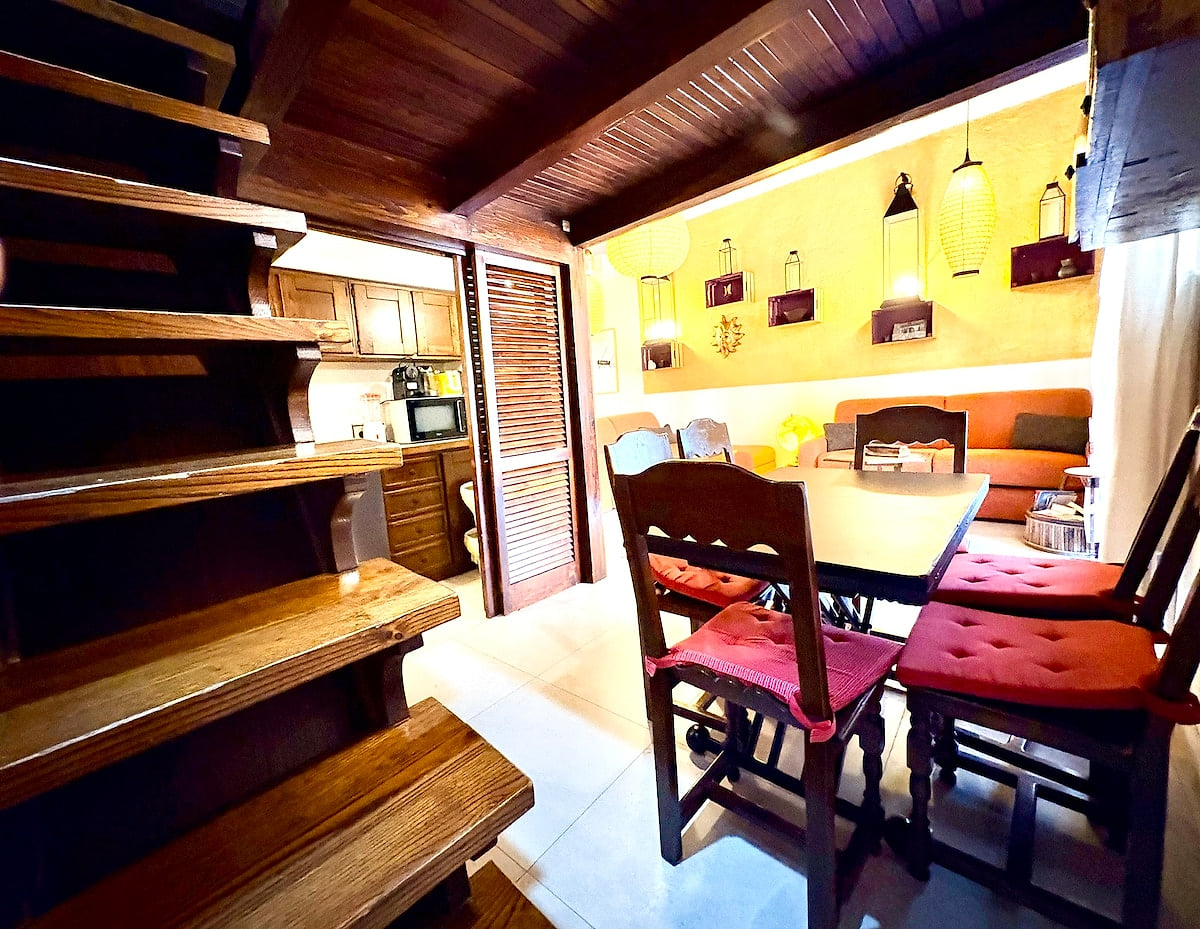6-person dining table right in front of the kitchen and connected to the living room