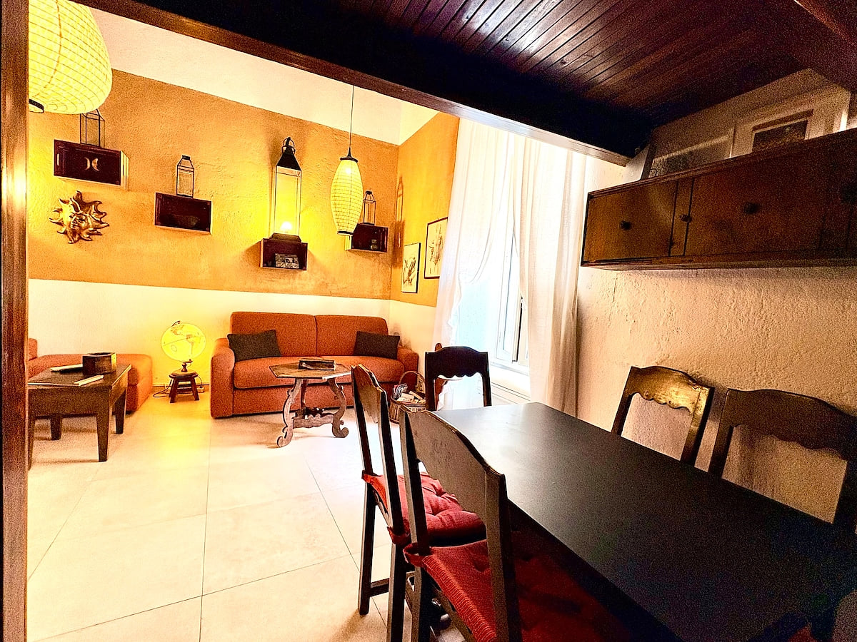 6-person dining table right in front of the kitchen and connected to the living room