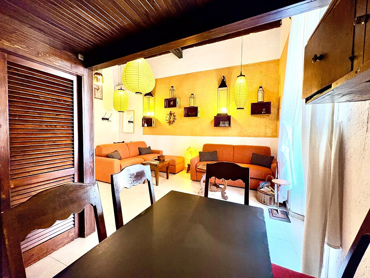 6-person dining table right in front of the kitchen and connected to the living room