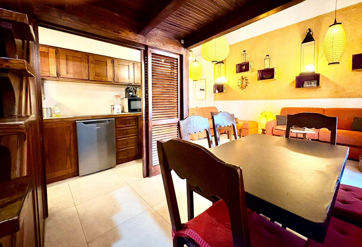 6-person dining table right in front of the kitchen and connected to the living room