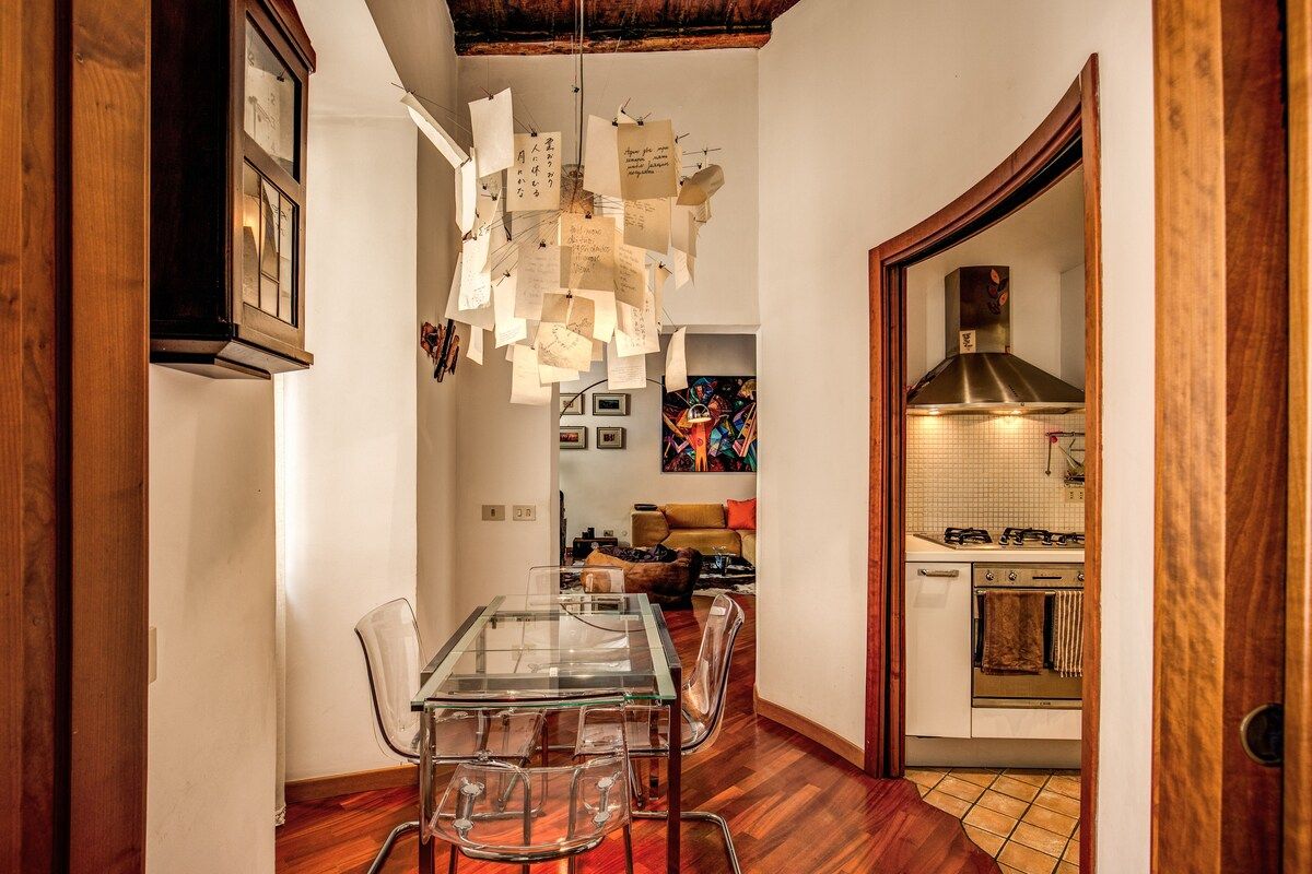table with chairs in a dining space in front of kitchen