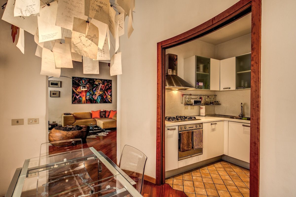 table with chairs in a dining space in front of kitchen