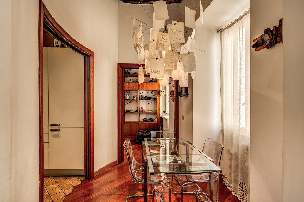 table with chairs in a dining space in front of kitchen