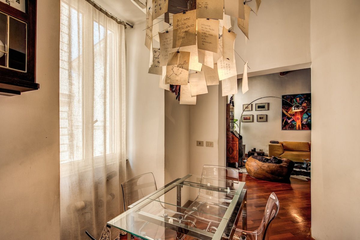 table with chairs in a dining space in front of kitchen
