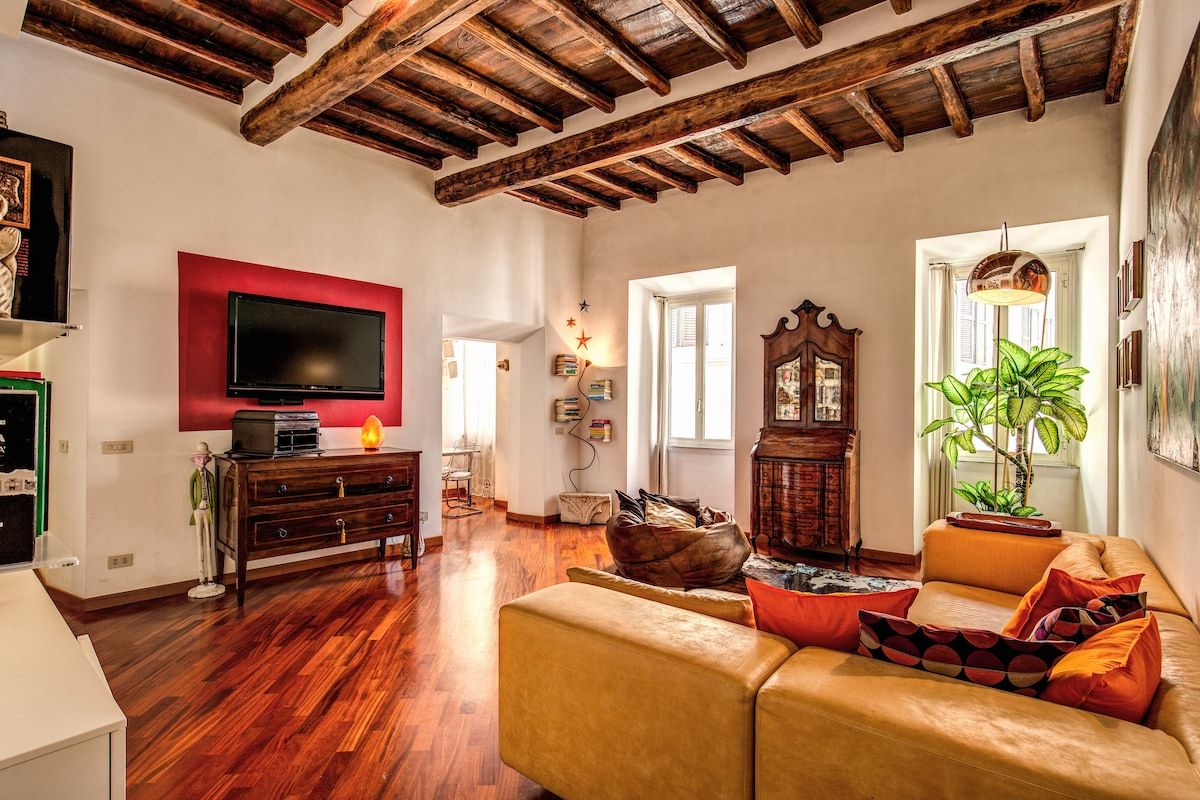 TV in big living room with parquet floors and original wooden beams of the 1500