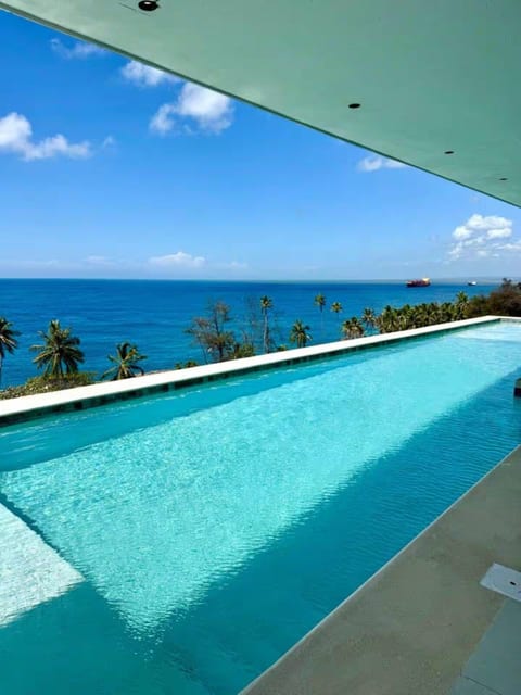 Oceanfront infinity pool with beautiful Caribbean Sea views, perfect for relaxing and enjoying the tropical setting.