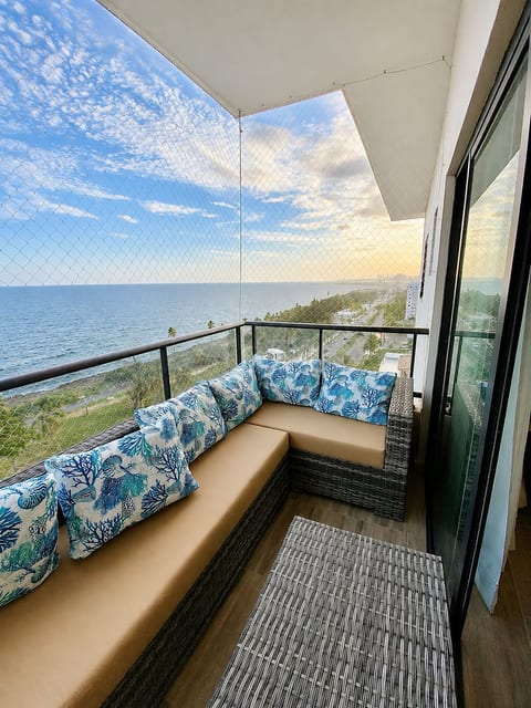 Private balcony with ocean views and a comfortable seating area, perfect for relaxing and enjoying the Caribbean breeze.