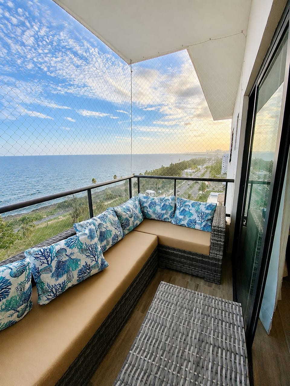 Private balcony with ocean views and a comfortable seating area, perfect for relaxing and enjoying the Caribbean breeze.