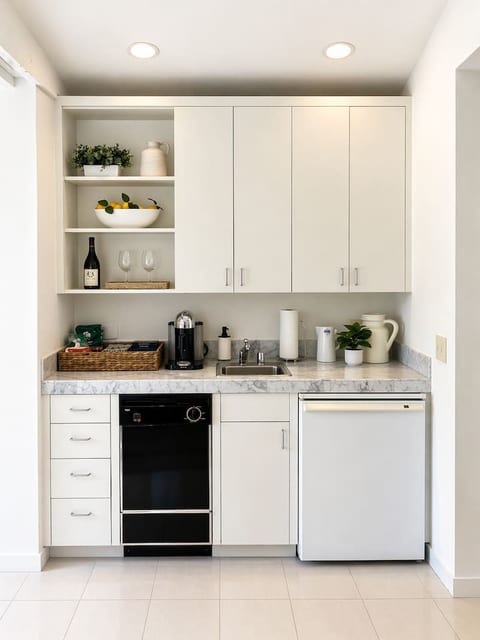 Convenient kitchenette equipped with a dishwasher, mini fridge, microwave, toaster, and Nespresso coffee maker. Ample cabinetry and counter space make it easy to prepare light meals, snacks, and your morning coffee.