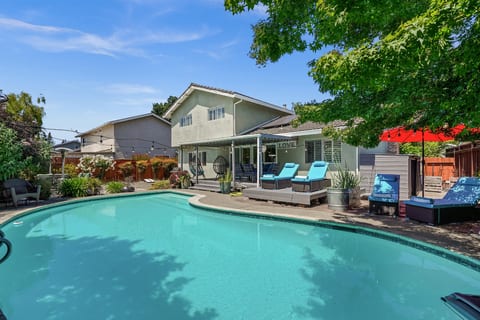 Private backyard retreat with a sparkling pool, outdoor seating, and space to relax and enjoy Napa Valley’s beautiful weather.