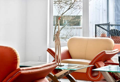 Bright modern lounge with designer seating and large sun-filled windows