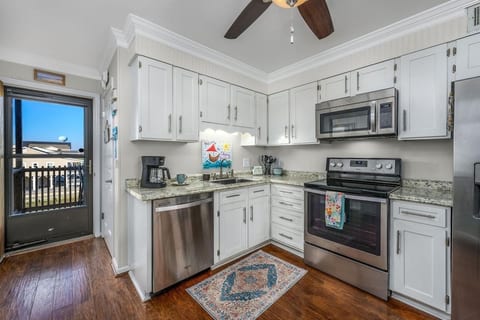 Fully equipped kitchen with various sizes of cookware and bakeware. 