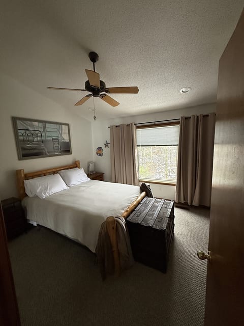 Black out curtains. Cozy bed with two firm, two soft pillows, cozy comforter. Extra blanket in closet. Two throws to cozy up. End table with plug ins and USB, makeup light with a 10x magnifier. Open the blinds to see the water. Smart Tv with Roku.