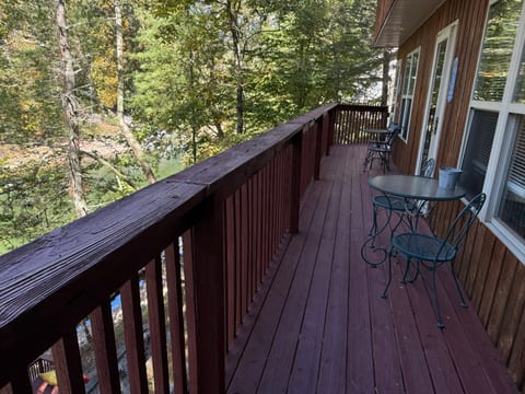 Step outside to the shared deck overlooking the wooded lakeside setting. Each condo has its own table and 2 chairs—perfect for morning coffee or fresh mountain air.