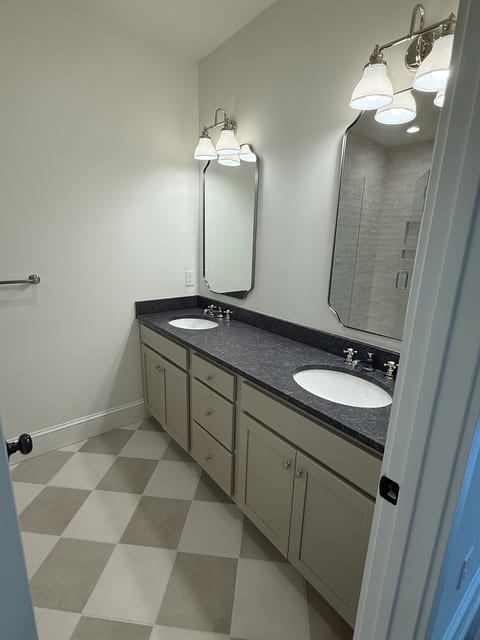 Bright double-vanity bathroom with ample storage and classic finishes