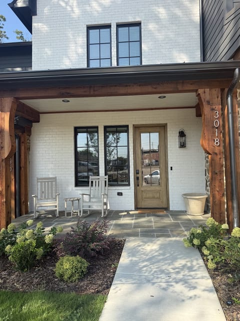 Inviting covered front porch with rocking chairs and charming curb appeal