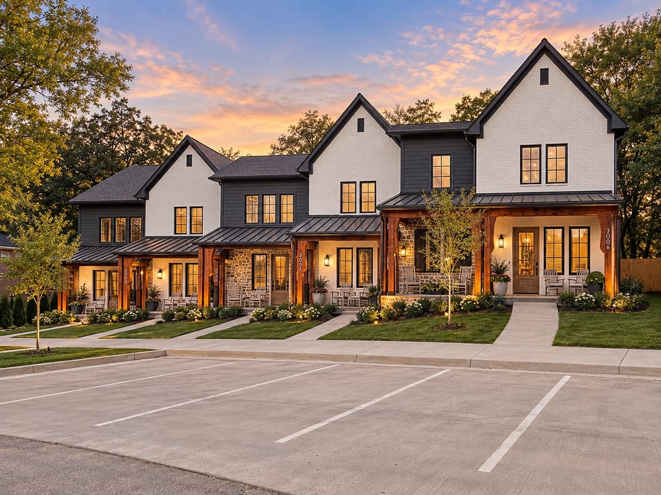 Charming modern townhomes with warm lighting and inviting curb appeal