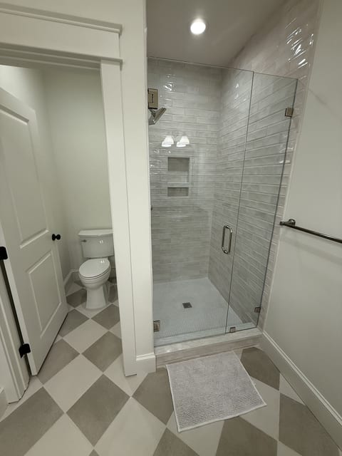 Bright modern bathroom with spacious walk-in glass shower