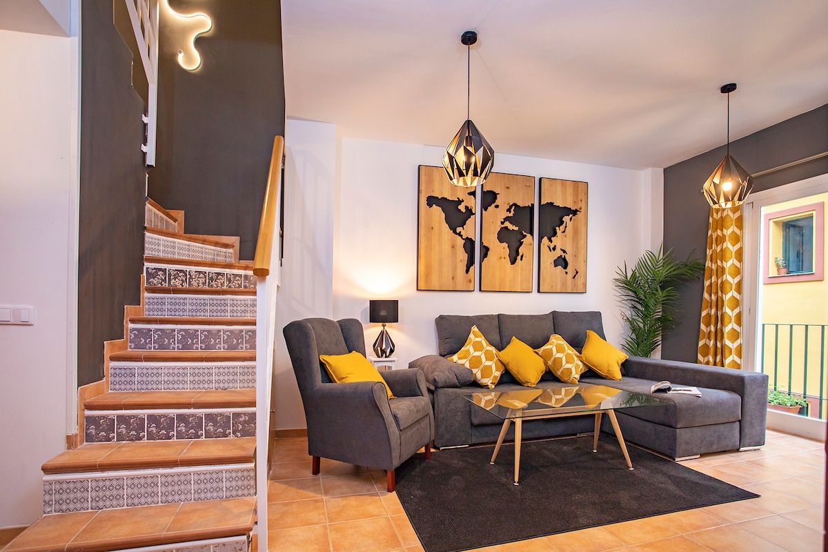 View of the sofa and staircase leading to the upper floor in the sleeping area