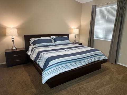 Master bedroom with a king bed, ensuite bath, walk-in closet, sound machine, and blackout curtains.