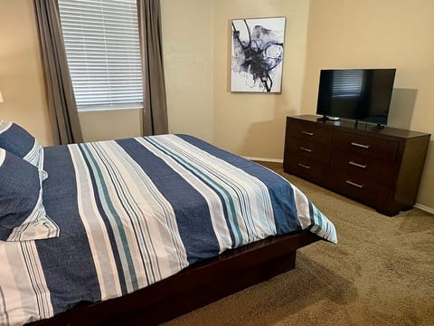 Master bedroom with a king bed, ensuite bath, walk-in closet, sound machine, and blackout curtains.