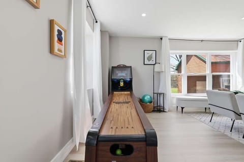 Bright game lounge with skee-ball and cozy seating by big windows
