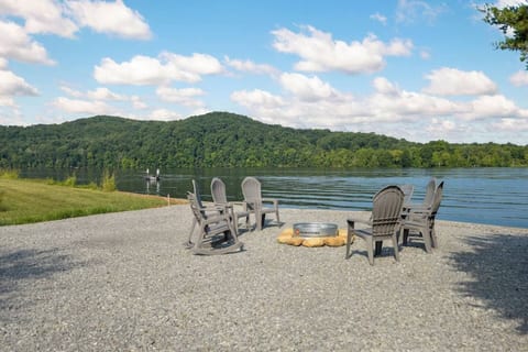Fire pit with Adirondack chairs right by the water’s edge—ideal for evening gatherings.