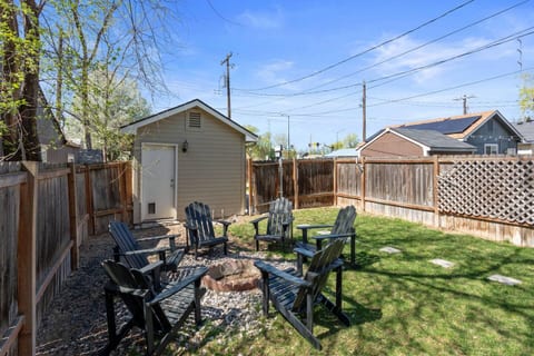 Enjoy a cozy night in by the fire pit! This inviting backyard space is perfect for unwinding with friends or family on comfortable Adirondack chairs.


