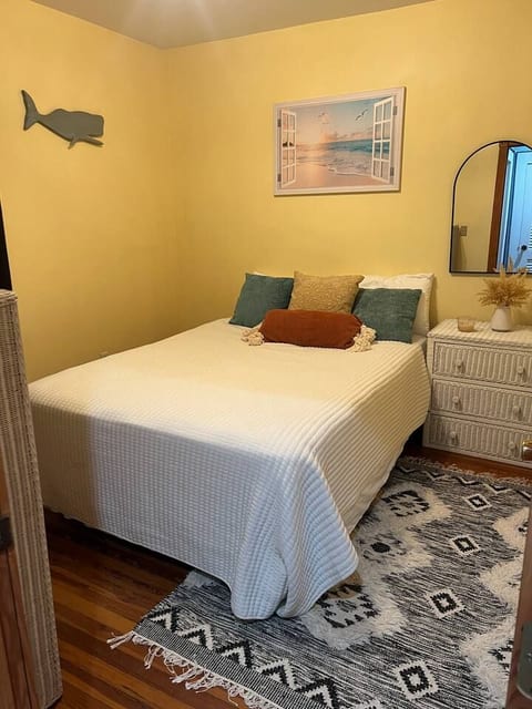 Unwind in your cozy private room featuring a comfortable queen-size bed, warm lighting, and unique coastal decor. A perfect retreat after a day of exploring.
