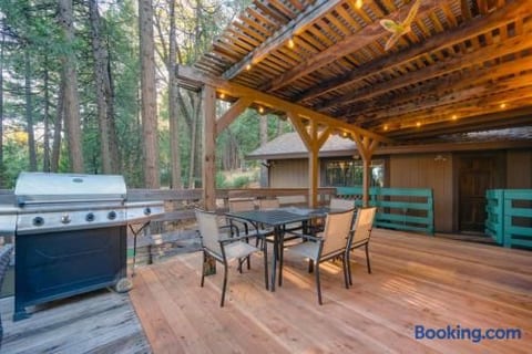 Covered forest-view deck with grill and outdoor dining area