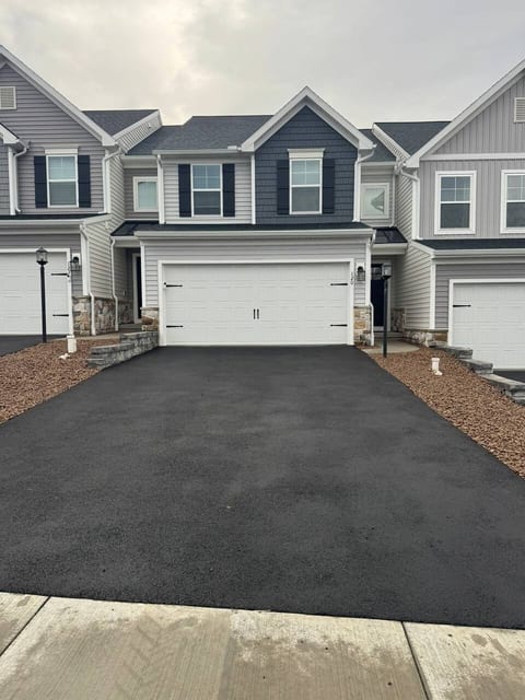 Modern townhouse with fresh curb appeal and spacious 2-car garage