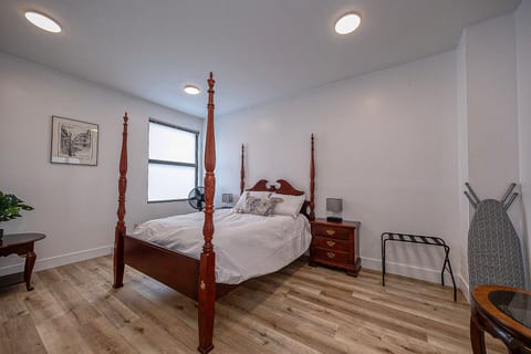 Spacious bedroom with elegant four-poster bed and guest-friendly amenities