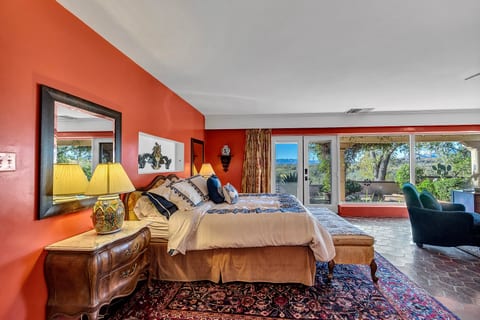 Spacious Southwestern bedroom with mountain views and sunny seating area